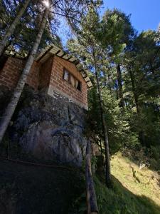 a brick building sitting on top of a mountain at Rancho buena vista in Mineral del Chico