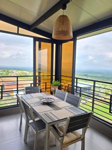 a dining room with a table and chairs on a balcony at Chalet - ENCANTO - Donde la Tranquilidad tiene la mejor Vista in El Cerrito