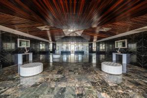 a large room with two tables and two stools at Beachfront Bliss at Isla Verde in San Juan +69 photos