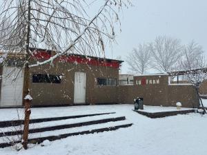 a building in the snow with a fire hydrant at Hostel Luxfran in Uspallata