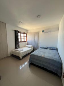 a bedroom with two beds and a window at Casa blue in Rodadero +32 photos