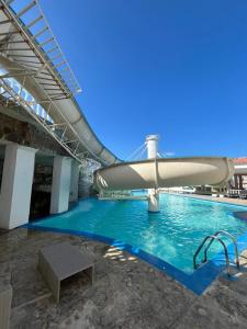a swimming pool with a slide in a building at Casa blue in Rodadero