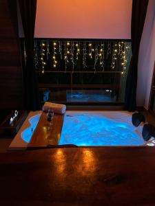 a jacuzzi tub in a room with lights at Chalé Carvalho in Araucária