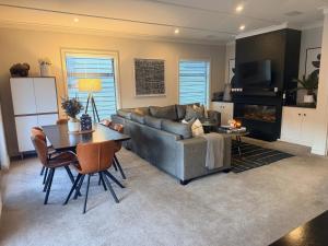 a living room with a couch and a table at Cardrona Mountain Villa in Cardrona
