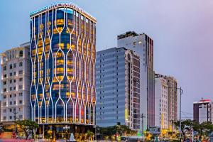 a tall building in a city with tall buildings at Stella Maris Beach Danang in Danang