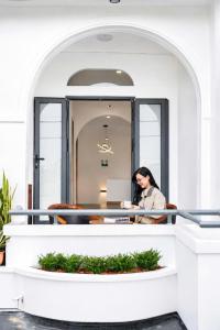 a woman sitting at a desk in an office at BY Home in Hue