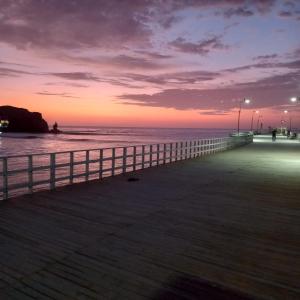 a view of a pier at sunset at Departamentos Cerro Azul P1 in Cerro Azul