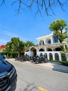 a group of motorcycles parked in front of a building at BY Home in Hue +24 photos