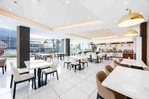 a dining room with tables and chairs in a restaurant at Citi Park Hotel Cebu powered by Cocotel in Cebu City
