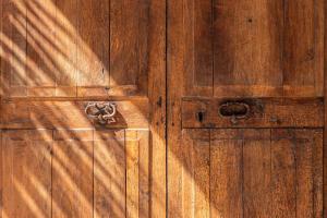 a wooden door with a metal knocker on it at Meliá Cala d'Or Boutique Hotel in Cala d´Or +57 photos