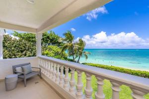 a balcony with a view of the ocean at 5-star Lanikai BEACHFRONT (5 bedrooms,sleeps 13) in Kailua