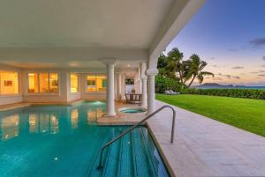 a swimming pool in the backyard of a house at 5-star Lanikai BEACHFRONT (5 bedrooms,sleeps 13) in Kailua