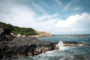 a view of the ocean with rocks in the water at Phu Yen Beachfront Fishing Village Homestay in Tuy Hoa +128 photos
