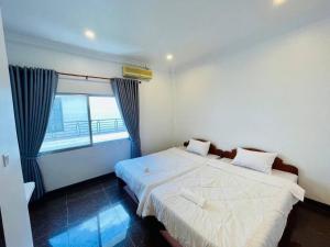a bedroom with two beds and a window at Peace And Cool Hotel in Siem Reap