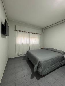 a bedroom with a bed and a window at Tortugas Hotel in Carlos Casares +14 photos