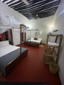 a bedroom with two bunk beds and a ladder at Tonys homestay in Zanzibar City
