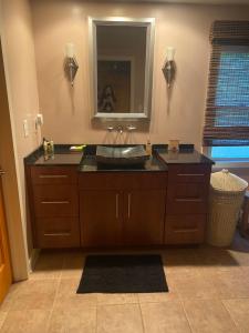 a bathroom with a sink and a mirror at Beacon Hill Lake House in Pinnacle +17 photos
