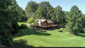 a large house in the middle of a green yard at Beacon Hill Lake House in Pinnacle