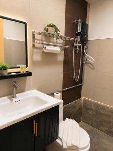a bathroom with a sink and a toilet and a mirror at Citto Inn Bangi in Bandar Baru Bangi