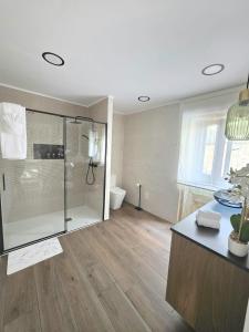a bathroom with a glass shower and a toilet at Casa Zoila in Porto do Son +31 photos