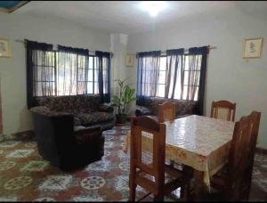 a living room with a table and a couch at Tunco SurfHouse in El Sunzal
