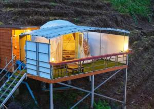 an overhead view of a tiny house with a blue roof at MonPhuView MonJam ม่อนภูวิว ม่อนแจ่ม in Mon Jam +4 photos