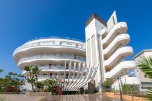 a large white building with a curved facade at SOL by Meliá Barbacan in Playa del Ingles