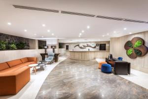 a lobby of a hotel with furniture and a bar at SOL by Meliá Barbacan in Playa del Ingles