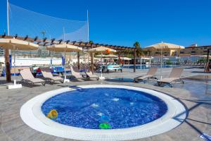 a small swimming pool with chairs and umbrellas at SOL by Meliá Barbacan in Playa del Ingles +73 photos