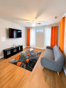 a living room with a couch and a flat screen tv at Private Villa - 3 Bedroom House in Raleigh