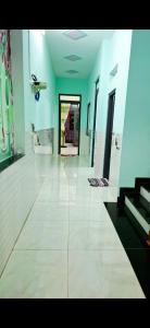 a large room with a white floor and blue walls at 846 A12 Bùi Thiện Ngộ in Cù Lao Tâu