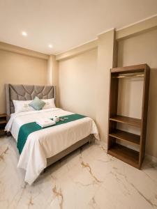 a bedroom with a large bed and a mirror at Libertad Grand Hotel in Ayacucho +3 photos