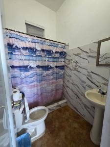a bathroom with a toilet and a sink at Relax en el pueblo 1 in Fajardo