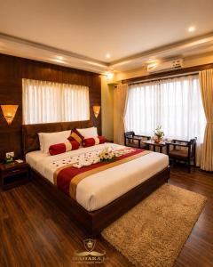 a large bedroom with a large bed and a desk at Maharaja Resort Pvt Ltd in Butwāl
