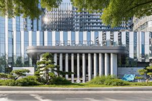 a large building in front of a tall building at Sheraton Xi'an Chanba in Xi'an