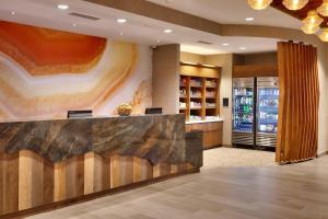 a hotel lobby with a reception desk and a painting at SpringHill Suites by Marriott Moab in Moab +120 photos