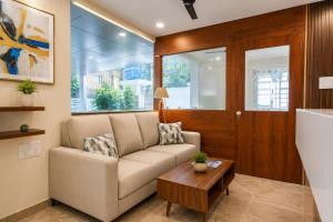 a living room with a couch and a table at Hotel Gokul Pride Near Secunderabad Railway station in Hyderabad