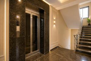 a hallway with a glass elevator in a building at Hotel Gokul Pride Near Secunderabad Railway station in Hyderabad