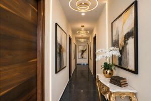 a hallway with paintings on the walls and a table at Hotel Gokul Pride Near Secunderabad Railway station in Hyderabad