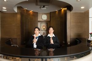 two people in a room with their hands in prayer at BU Place Hotel in Bangkok
