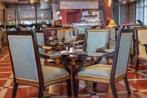 a table and chairs in a restaurant at Shkodër Grand Hotel Europa, Affiliated by Meliá in Shkodër