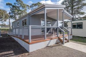 a modular home with a porch and a deck at Beaufort Lake Caravan Park in Beaufort