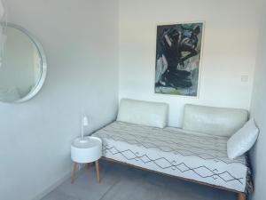 a white couch in a room with a mirror at City Loft in Freudenstadt