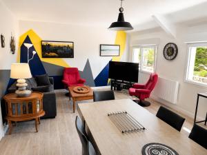 a living room with a couch and a table at An Dorzell beach 60 meters in Cléder