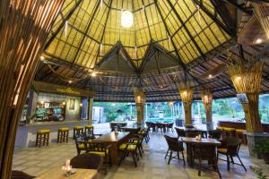 a restaurant with tables and chairs and a large ceiling at Samui Honey Tara Villa Residence in Choeng Mon Beach