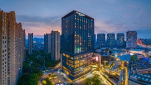 a tall building in a city at night at Courtyard by Marriott Suzhou Mudu in Suzhou