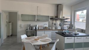 a kitchen with a table and chairs in a room at City Loft in Freudenstadt +13 photos