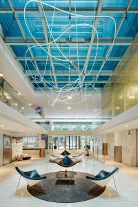 a lobby with blue ceilings and chairs in a building at Sercotel Caspe in Barcelona