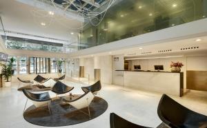 a lobby with chairs and a reception desk at Sercotel Caspe in Barcelona
