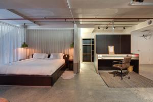 a bedroom with a bed and a desk and a computer at Zara Tower – Luxury Suites and Apartments in Sydney +160 photos